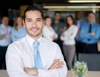 Portrait of a confident successful man leading a business group and looking at the camera